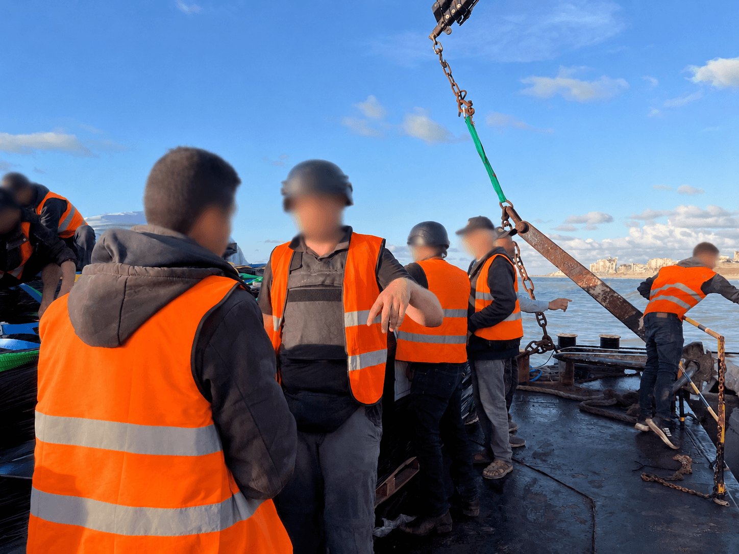 A team working a waterside lift during a maritime relief operation